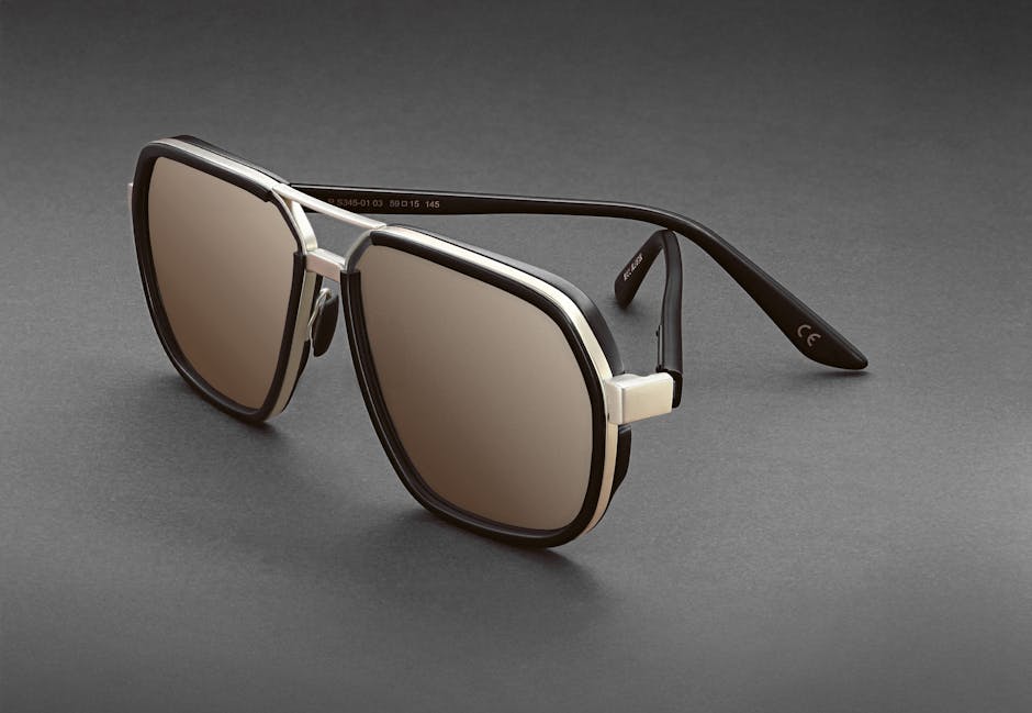 Elegant black and silver aviator sunglasses with tinted lenses on a grey backdrop, perfect for fashion and style.