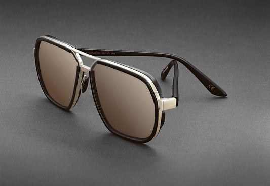 Elegant black and silver aviator sunglasses with tinted lenses on a grey backdrop, perfect for fashion and style.