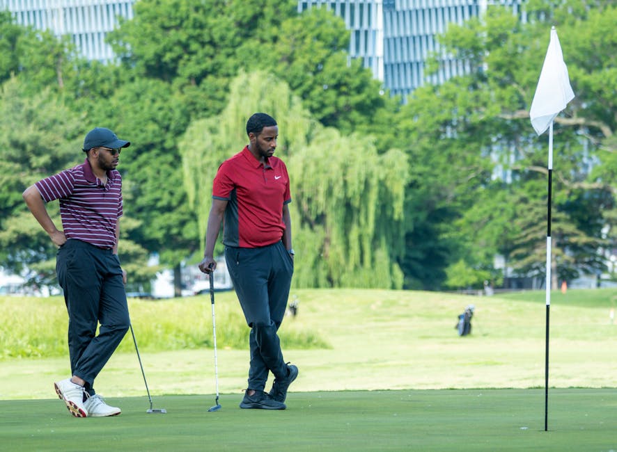 Two male golfers strategize near the hole on a sunny day in Washington, DC.