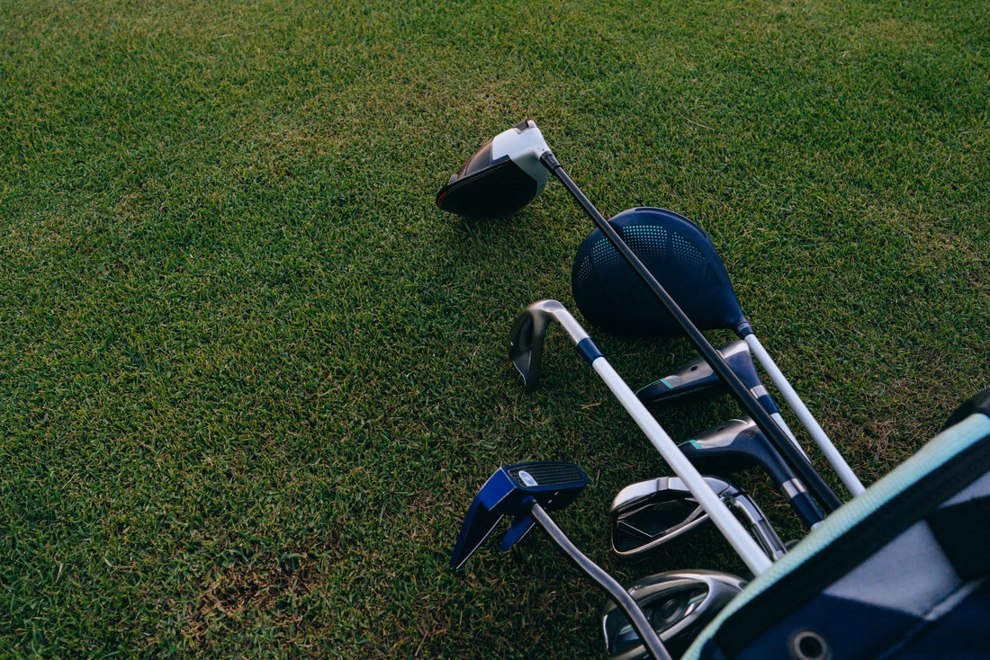 Close-up of golf clubs on a green lawn, ideal for golfing enthusiasts.