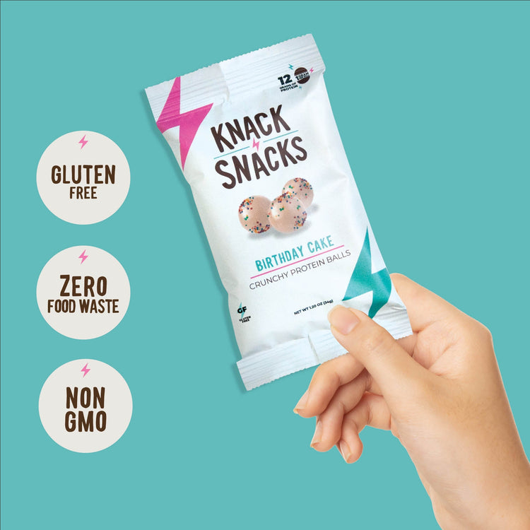 Selection of Knacks Snacks Protein balls, pork scratchings, and assorted healthy snacks, ideal for golfers and padel players.